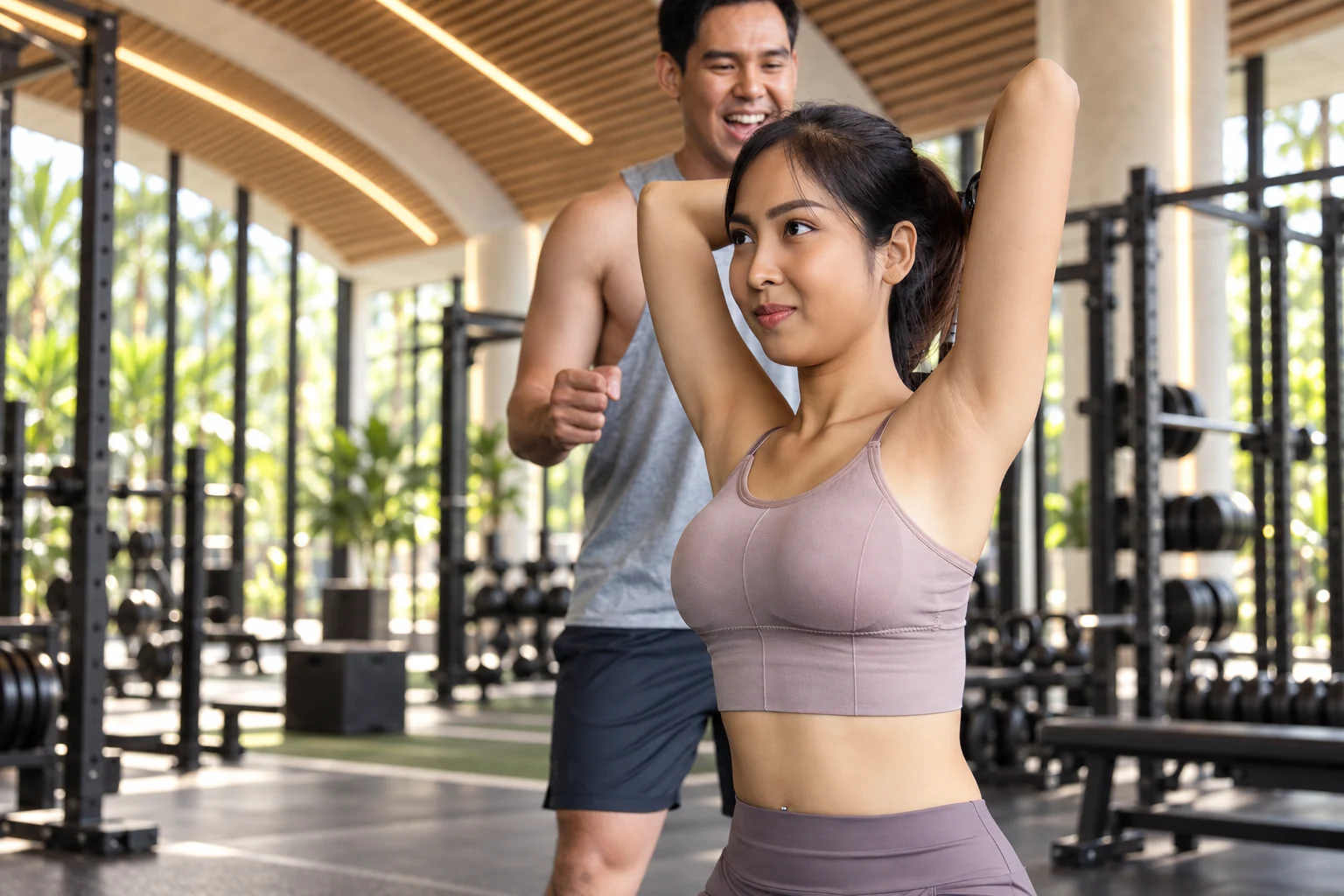 Supplied concept image of a woman doing a seated triceps exercise with a trainer